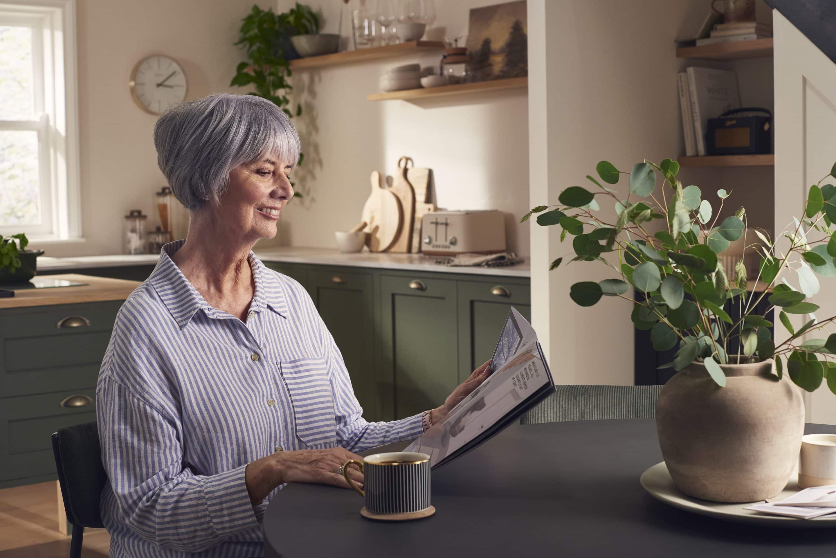 Image of a woman looking through a stairlift brochure